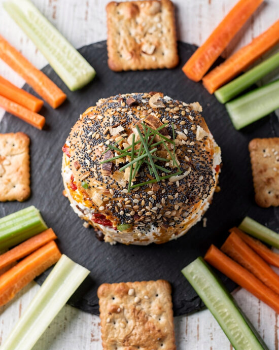 A creamy, golden cheese ball rolled in a crunchy coating of toasted walnuts and everything bagel seasoning, ready to amplify snack brands on your appetizer table.