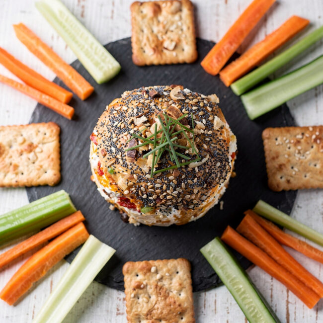 A creamy, golden cheese ball rolled in a crunchy coating of toasted walnuts and everything bagel seasoning, ready to amplify snack brands on your appetizer table.