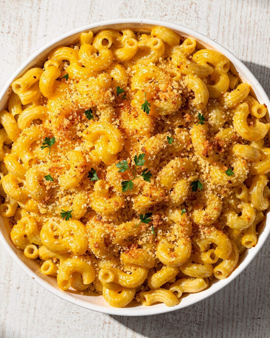A golden-brown baked mac and cheese recipe, fresh from the oven, with crispy topping and creamy cheese sauce visible.
