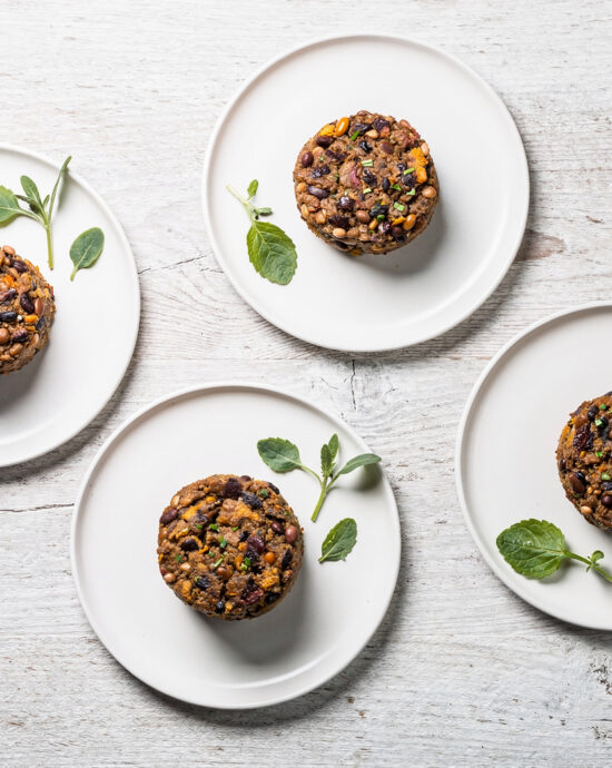 Two perfectly seared bean burgers with vibrant toppings on a toasted bun, ready to be enjoyed.