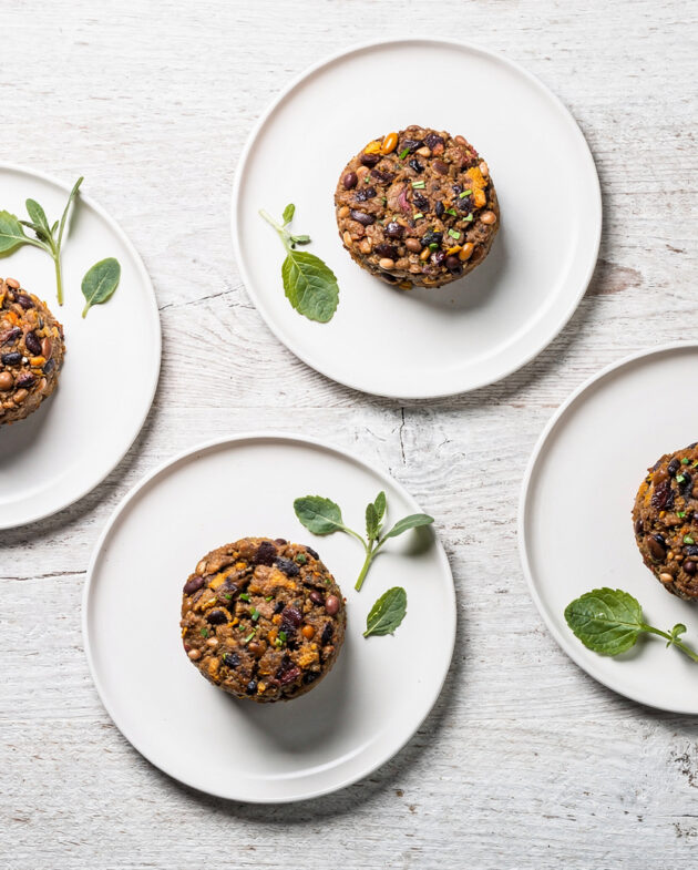 Two perfectly seared bean burgers with vibrant toppings on a toasted bun, ready to be enjoyed.