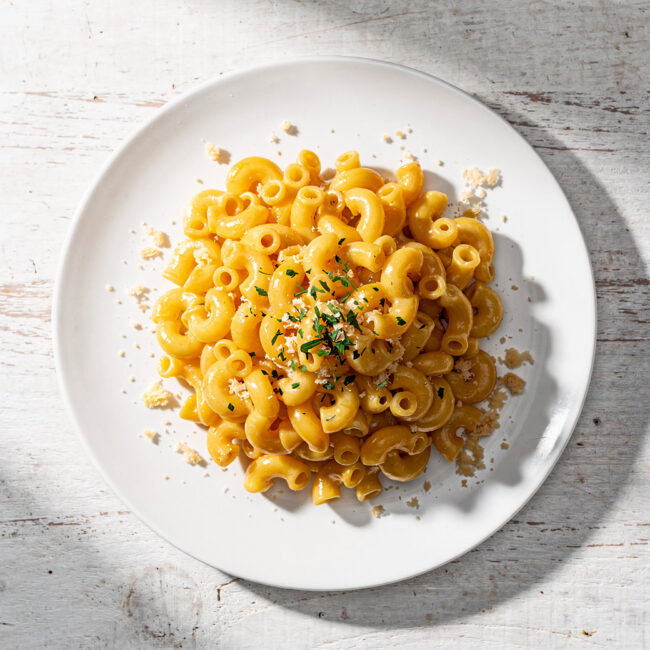 A golden, bubbling baking dish of the best gluten free mac and cheese, ready to be served.
