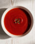 A velvety bowl of the best tomato soup brand, topped with fresh basil and a swirl of cream.