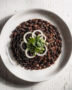 A steaming bowl of hearty black beans brazilian stew served over fluffy white rice.