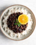 A steaming bowl of rich black beans brazilian, ready to be enjoyed.