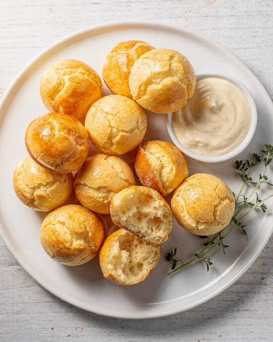 Golden brown brazilian bread cheese recipe fresh from the oven on a wooden board.