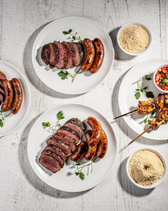 Sliced picanha steak from a traditional brazilian churrasco resting on a wooden board, showcasing a perfect crust.