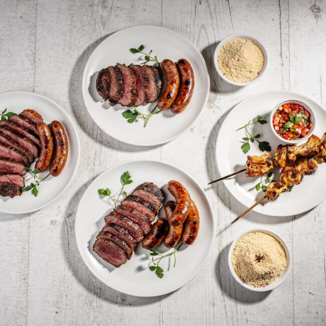 Sliced picanha steak from a traditional brazilian churrasco resting on a wooden board, showcasing a perfect crust.