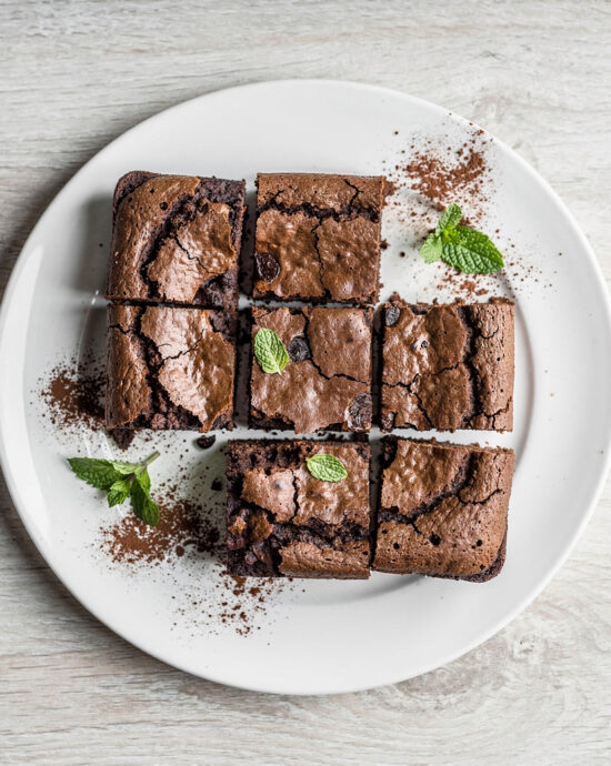 A beautifully baked brownie cake recipe presented on a rustic wooden table.