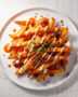 A heaping platter of crispy buffalo fries drizzled with blue cheese dressing sits ready to be devoured.