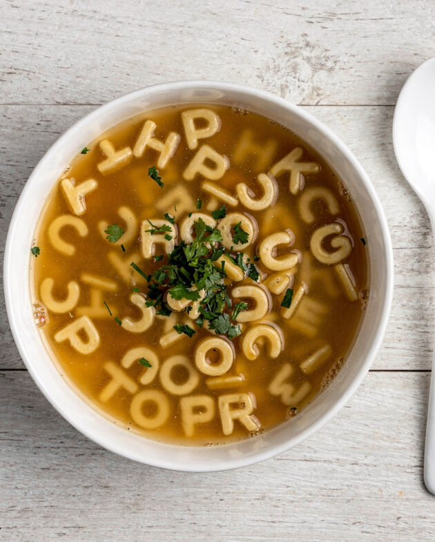 A creamy bowl of homemade campbell's abc soup with tiny alphabet pasta and a swirl of cream.