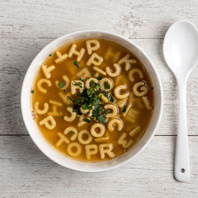 A creamy bowl of homemade campbell's abc soup with tiny alphabet pasta and a swirl of cream.