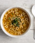 A creamy bowl of homemade campbell's abc soup with tiny alphabet pasta and a swirl of cream.