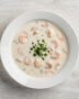 A creamy, inviting bowl of campbell's cream of shrimp soup garnished with fresh parsley, perfect for a cozy meal.