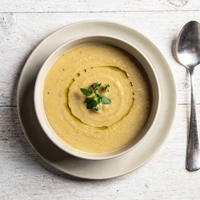 A steaming bowl of homemade campbell's yes soup, creamy and inviting, with a sprinkle of fresh herbs.