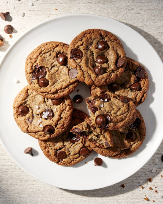 A stack of warm, chewy chocolate chip cookies from our perfect chocolate chip recipe, ready to be enjoyed.