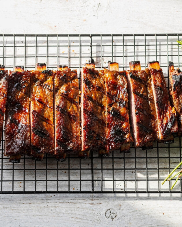 A perfectly grilled rack of ribs showcasing the ideal cook time for ribs on grill, with a dark caramelized crust and visible smoke ring.
