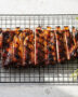 A perfectly grilled rack of ribs showcasing the ideal cook time for ribs on grill, with a dark caramelized crust and visible smoke ring.