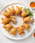 A golden platter of freshly fried crab rangoon recipe, showcasing their crisp texture and creamy filling.