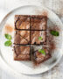 A close-up, overhead shot of a pan of freshly baked gluten free brownies with a cracked, shiny top.
