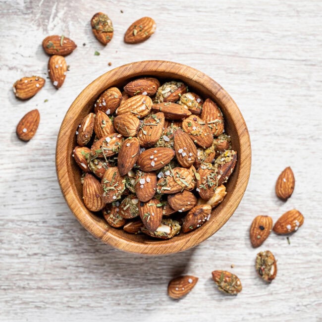 A rustic bowl filled with savory herb almond mix, showcasing the best of healthy snacks at walgreens for a quick and delicious bite.