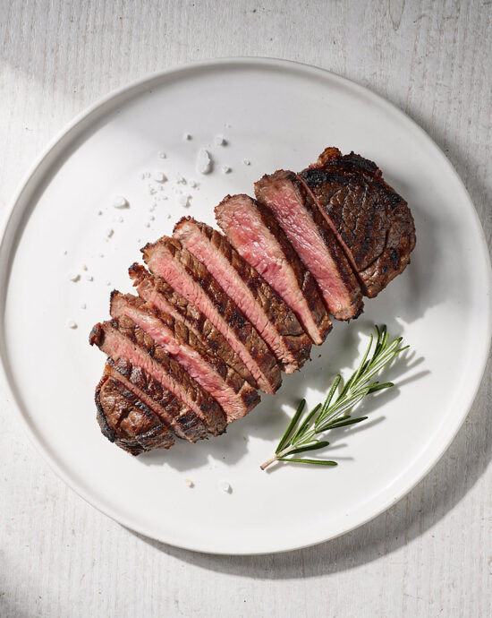 A perfectly grilled ribeye steak, demonstrating how to grill the perfect steak with a deep char and juicy interior.