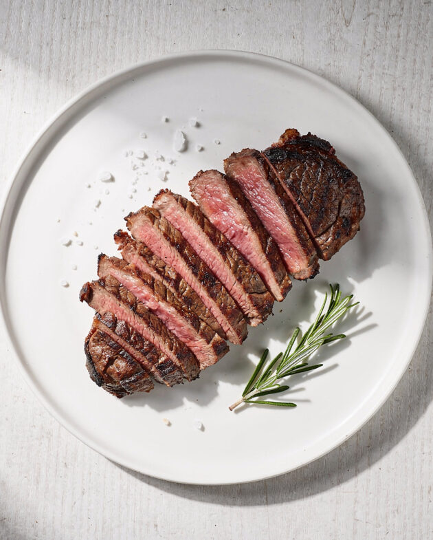 A perfectly grilled ribeye steak, demonstrating how to grill the perfect steak with a deep char and juicy interior.