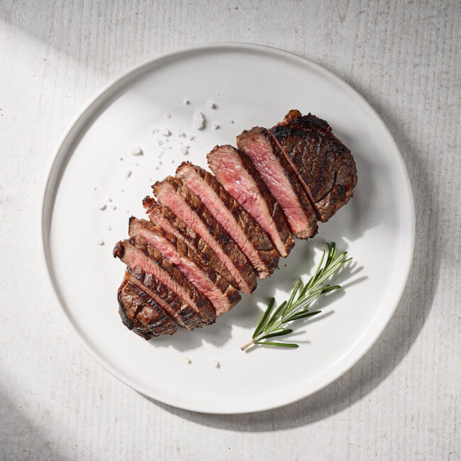 A perfectly grilled ribeye steak, demonstrating how to grill the perfect steak with a deep char and juicy interior.