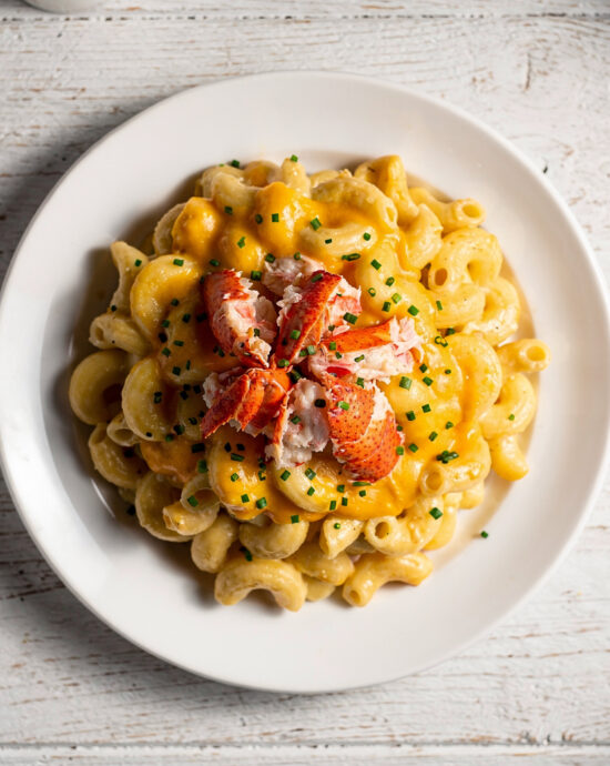 A golden, bubbling lobster mac and cheese fresh from the oven, ready to serve.