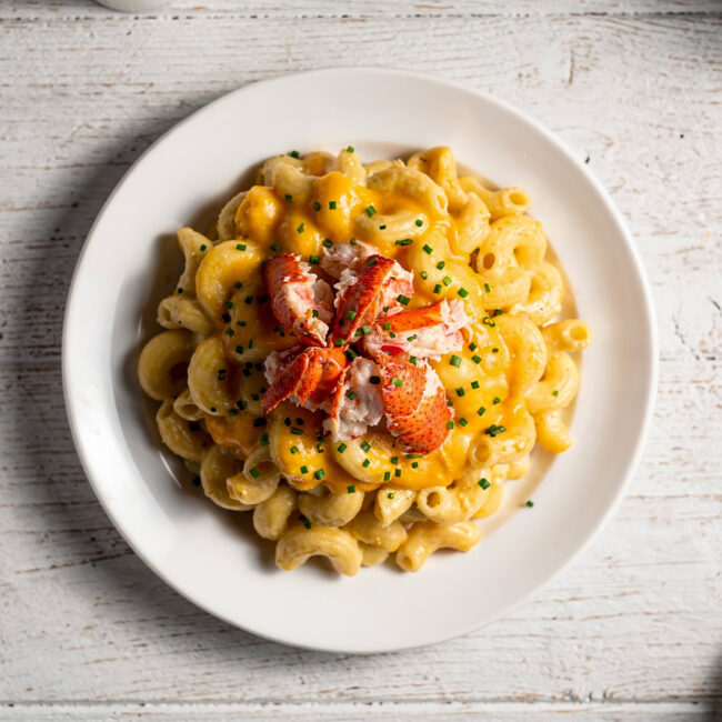 A golden, bubbling lobster mac and cheese fresh from the oven, ready to serve.
