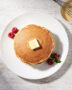 A perfectly stacked plate of fluffy golden pancakes made from this easy pancake mix recipe, drizzled with maple syrup.