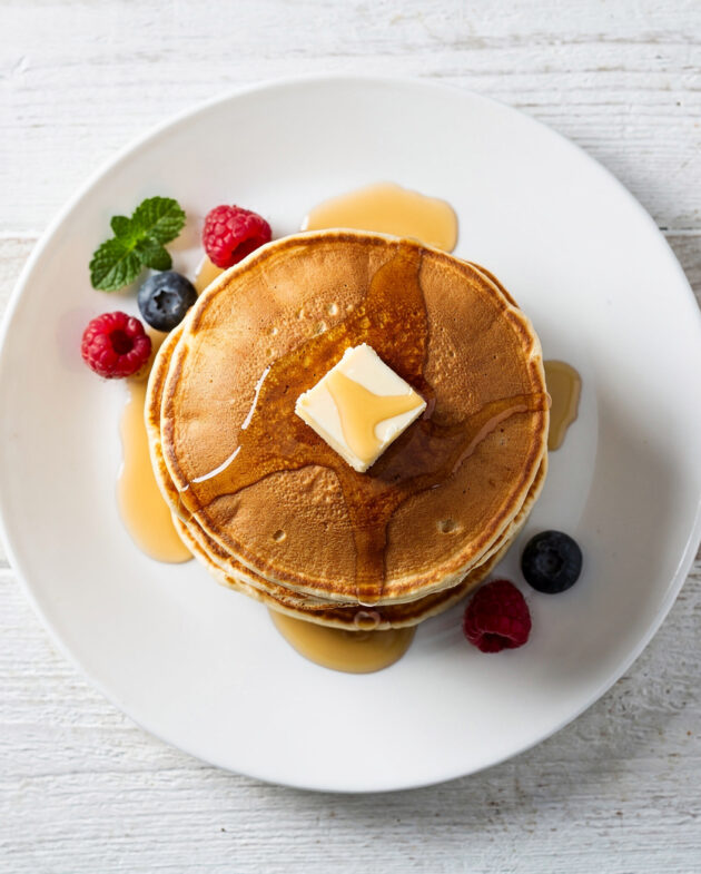 A perfect stack of golden-brown pancakes made from this simple pancake recipe without eggs.