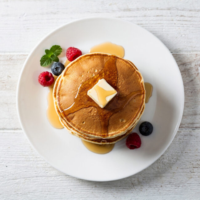 A perfect stack of golden-brown pancakes made from this simple pancake recipe without eggs.