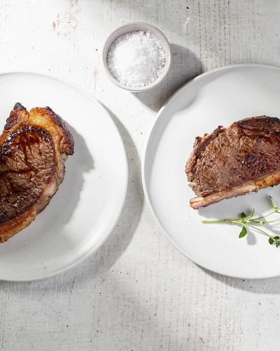 Perfectly grilled picanha steaks resting on a wooden board, showcasing a deep caramelized crust and juicy interior.
