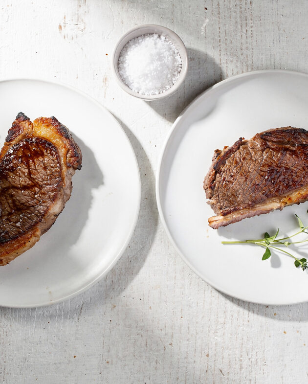 Perfectly grilled picanha steaks resting on a wooden board, showcasing a deep caramelized crust and juicy interior.