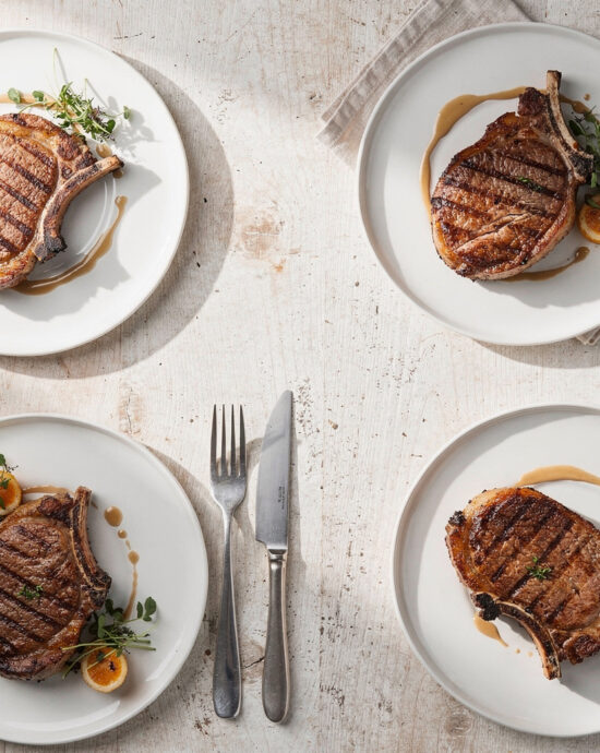 Golden brown pork chop recipes with a fragrant garlic-herb crust, ready to be enjoyed.