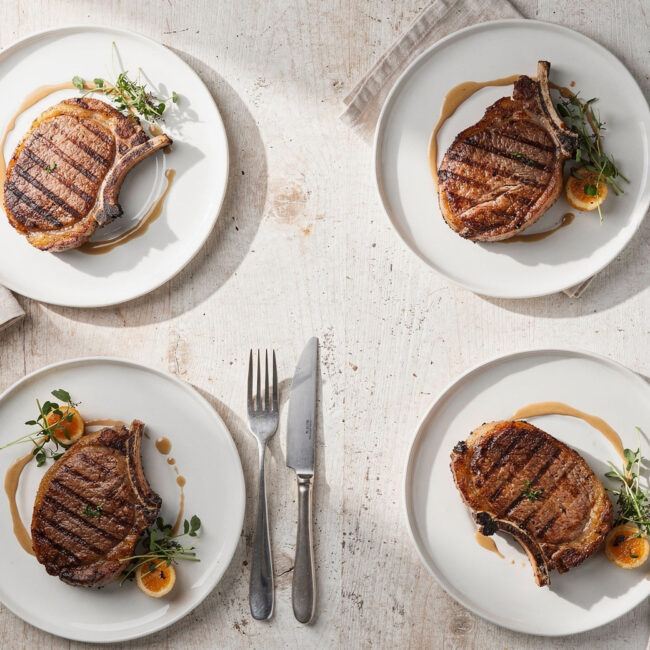Golden brown pork chop recipes with a fragrant garlic-herb crust, ready to be enjoyed.