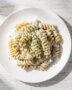 A creamy, perfectly sauced ranch pasta recipe served in a rustic white bowl, garnished with fresh herbs.