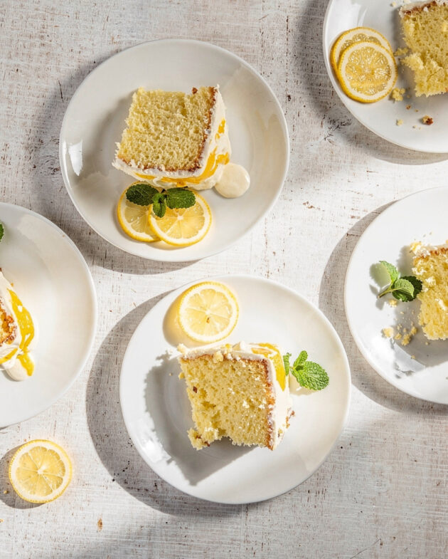 A slice of moist lemon drizzle cake made from easy recipes with lemon cake mix, resting on a wooden board.