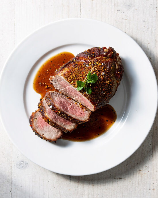 A succulent pot roast with french onion soup mix, glistening with savory gravy in a cast iron Dutch oven.