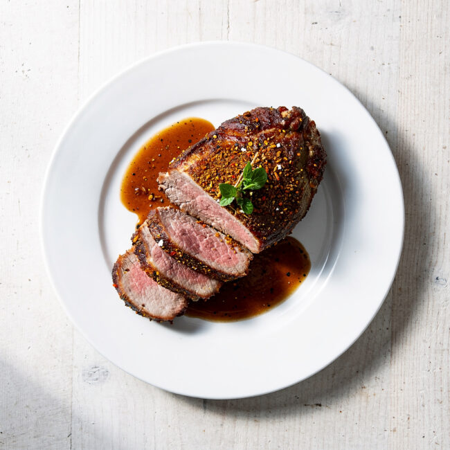 A succulent pot roast with french onion soup mix, glistening with savory gravy in a cast iron Dutch oven.