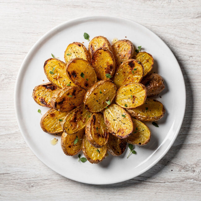 A golden-brown batch of crispy roasted potatoes with onion soup mix, perfectly seasoned and ready to serve.