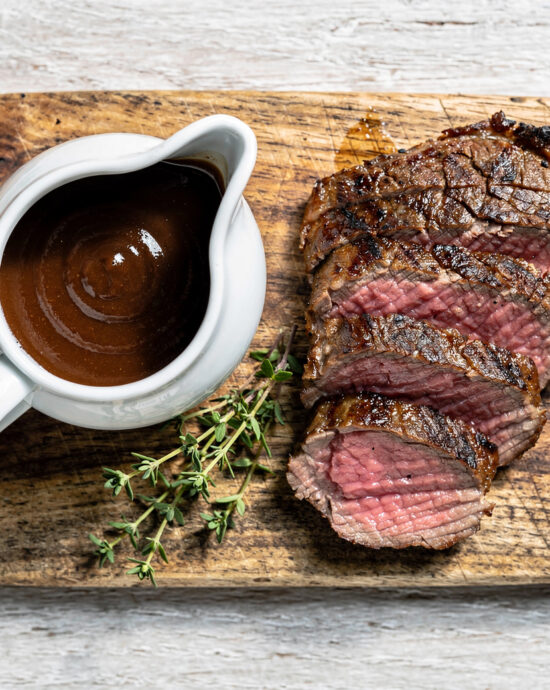 A glossy, rich homemade best steak sauce drizzled over a perfectly grilled steak.