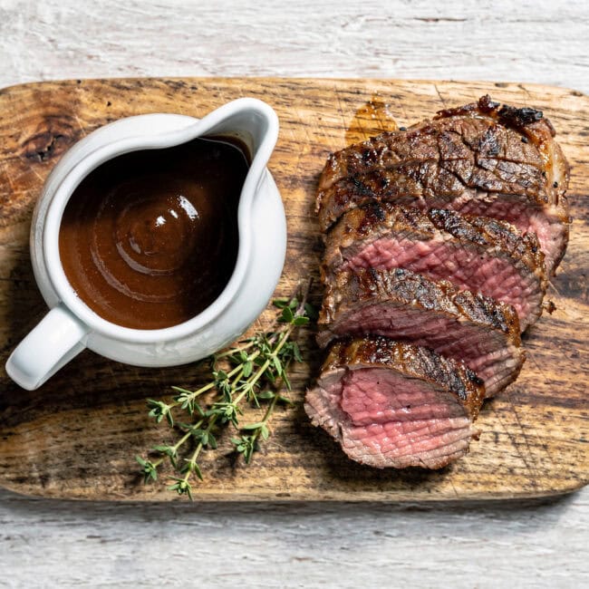 A glossy, rich homemade best steak sauce drizzled over a perfectly grilled steak.