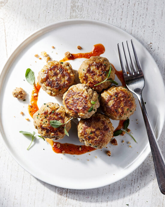 A beautifully plated turkey meatball recipe with a vibrant herby lemon-garlic sauce.