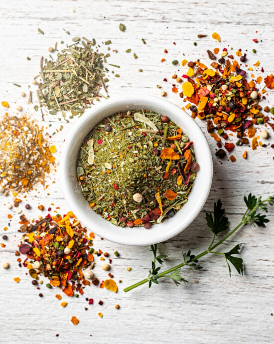 A rustic bowl of homemade vegetable soup sits on a wooden table, showcasing the rich color and texture achieved with a perfect homemade vegetable soup seasoning.