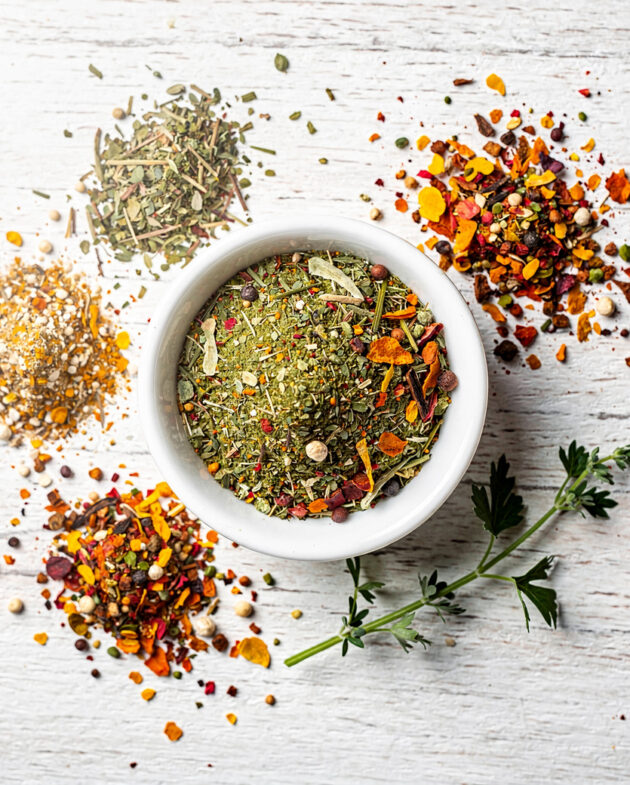 A rustic bowl of homemade vegetable soup sits on a wooden table, showcasing the rich color and texture achieved with a perfect homemade vegetable soup seasoning.