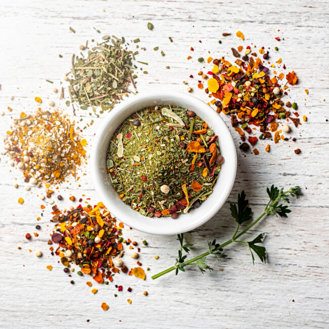 A rustic bowl of homemade vegetable soup sits on a wooden table, showcasing the rich color and texture achieved with a perfect homemade vegetable soup seasoning.