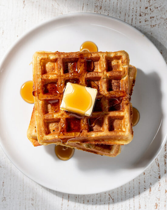 A golden, crisp waffle fresh from the iron, showcasing the perfect texture from this waffle batter recipe.