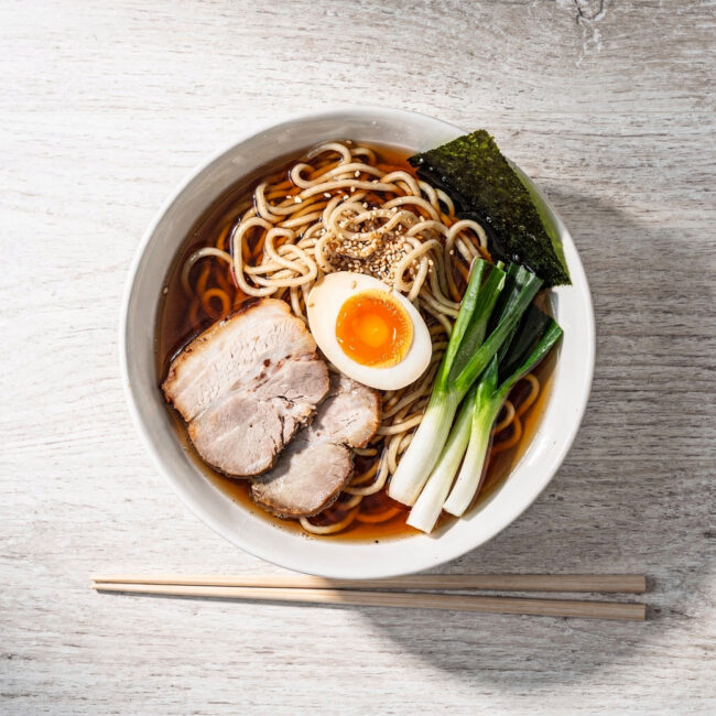A vibrant bowl of homemade ramen noodle recipe featuring springy noodles, a rich soy-based broth, and perfect toppings like a jammy egg and chashu pork.